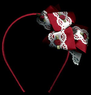 grosgrain and perforated ribbon multi loop bow with rosettes on headband